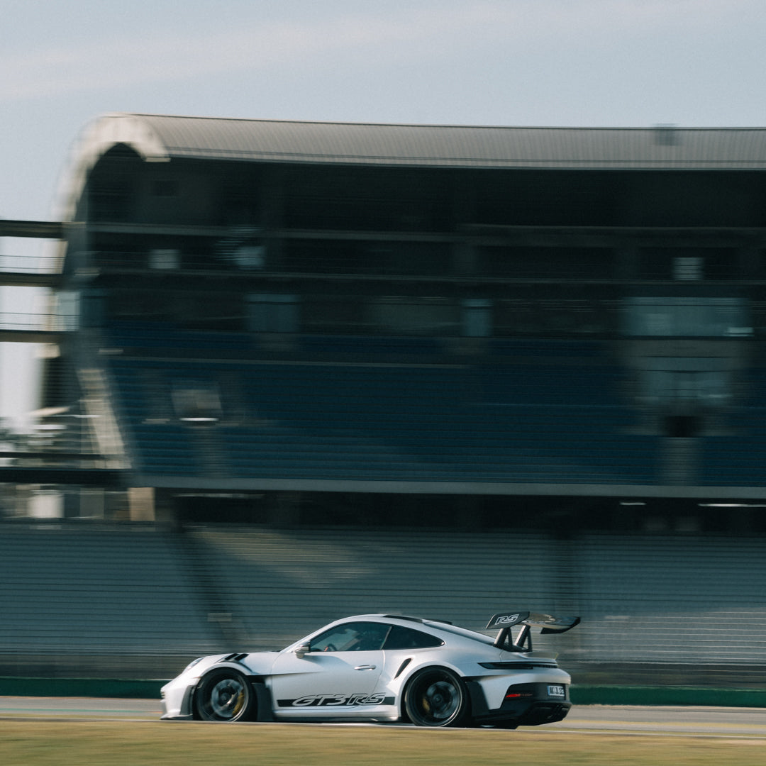 Silver Porsche 911 GT3 RS in front of the start-finish grandstand at the Hockenheimring at an Afterwork Trackday