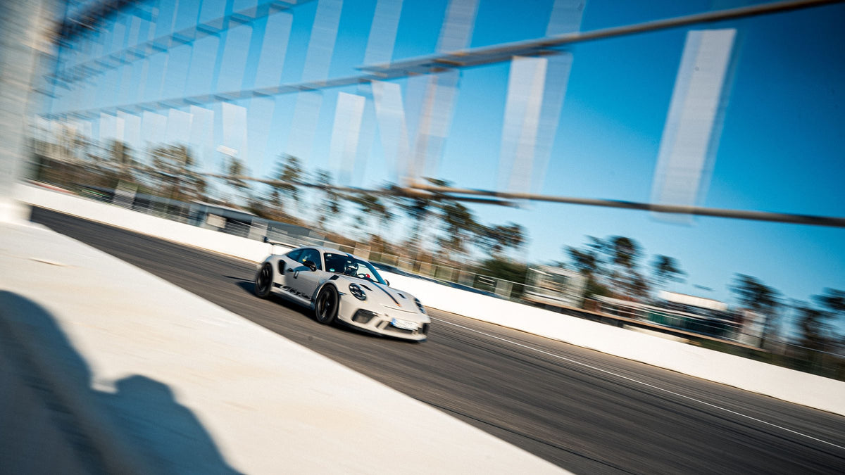 Orange Alpine A110 in a panning shot on the circuit